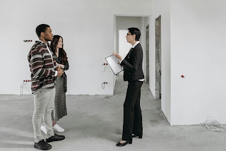Real estate broker talking with renters.
